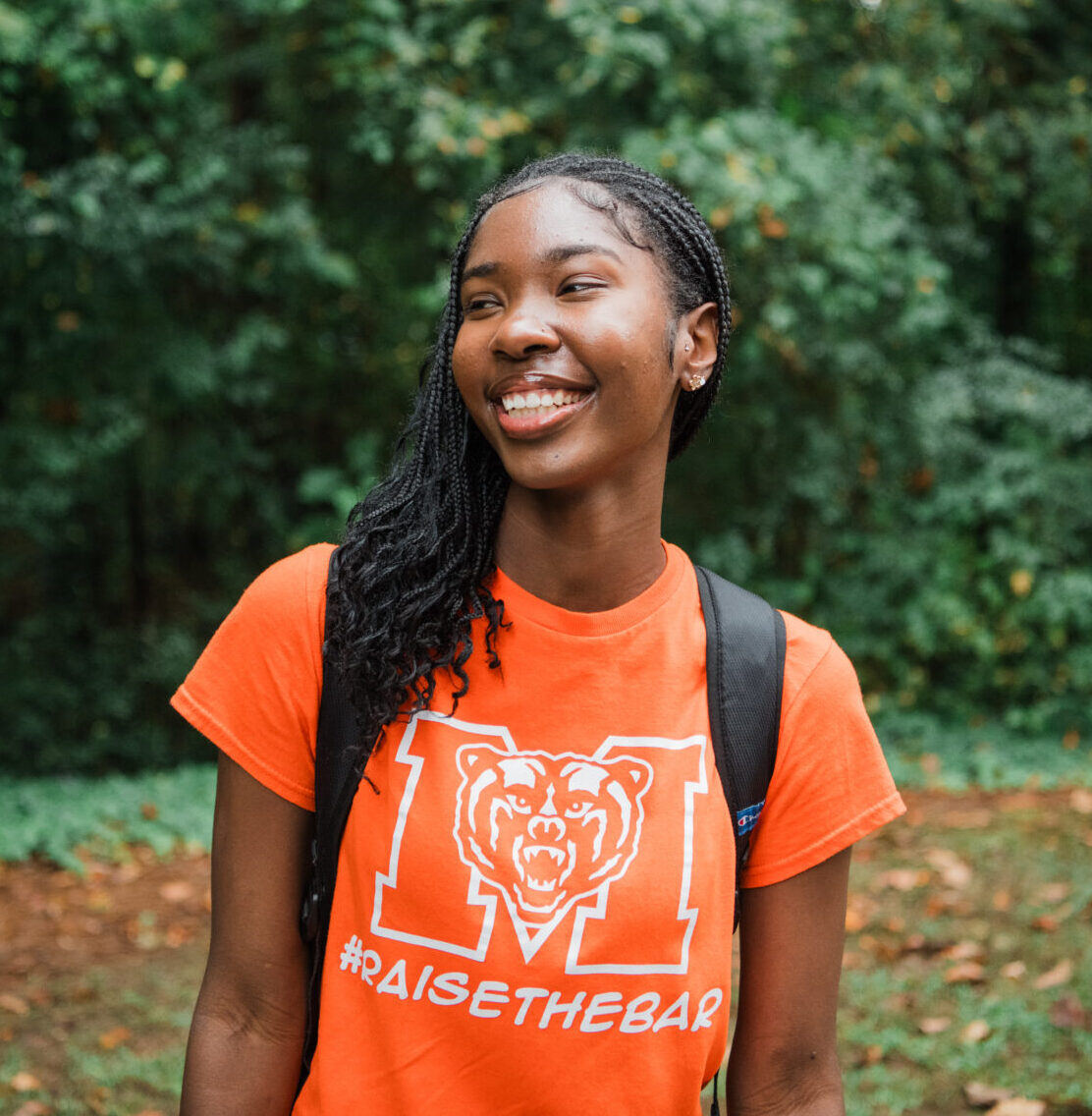 Mercer Nursing student in orange Mercer shirt smiling