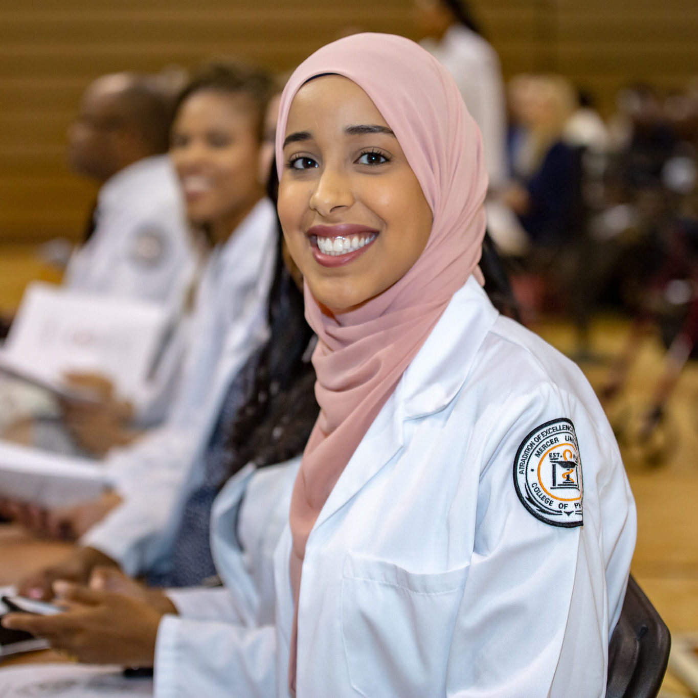 a pharmacy student in a white coat