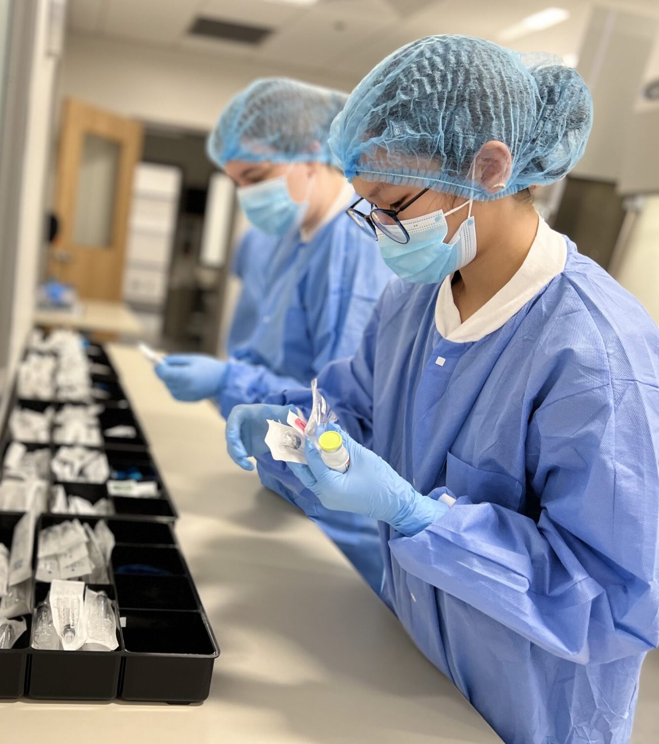 Pharmacy students working in a sim lab