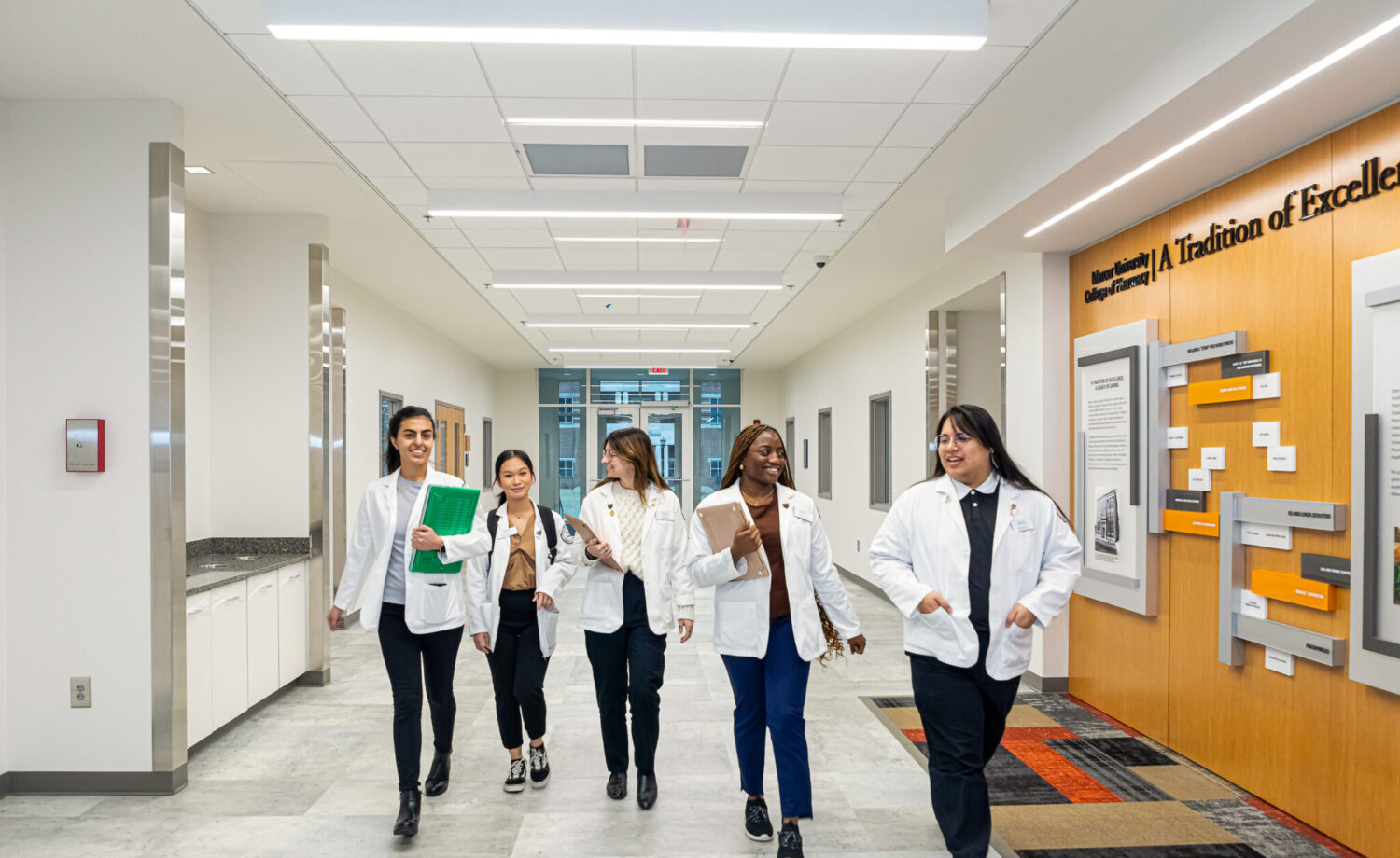 Mercer pharmacy students walking inside the Moye Building