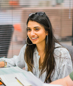 female counseling student learning in classroom and smiling