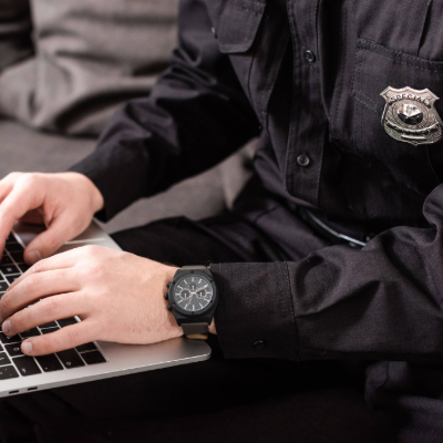 Law professional's hands typing on a laptop.