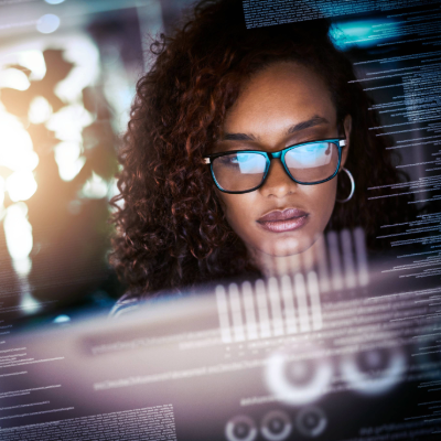 woman looking at computer with a technology graphics overlay on the photo