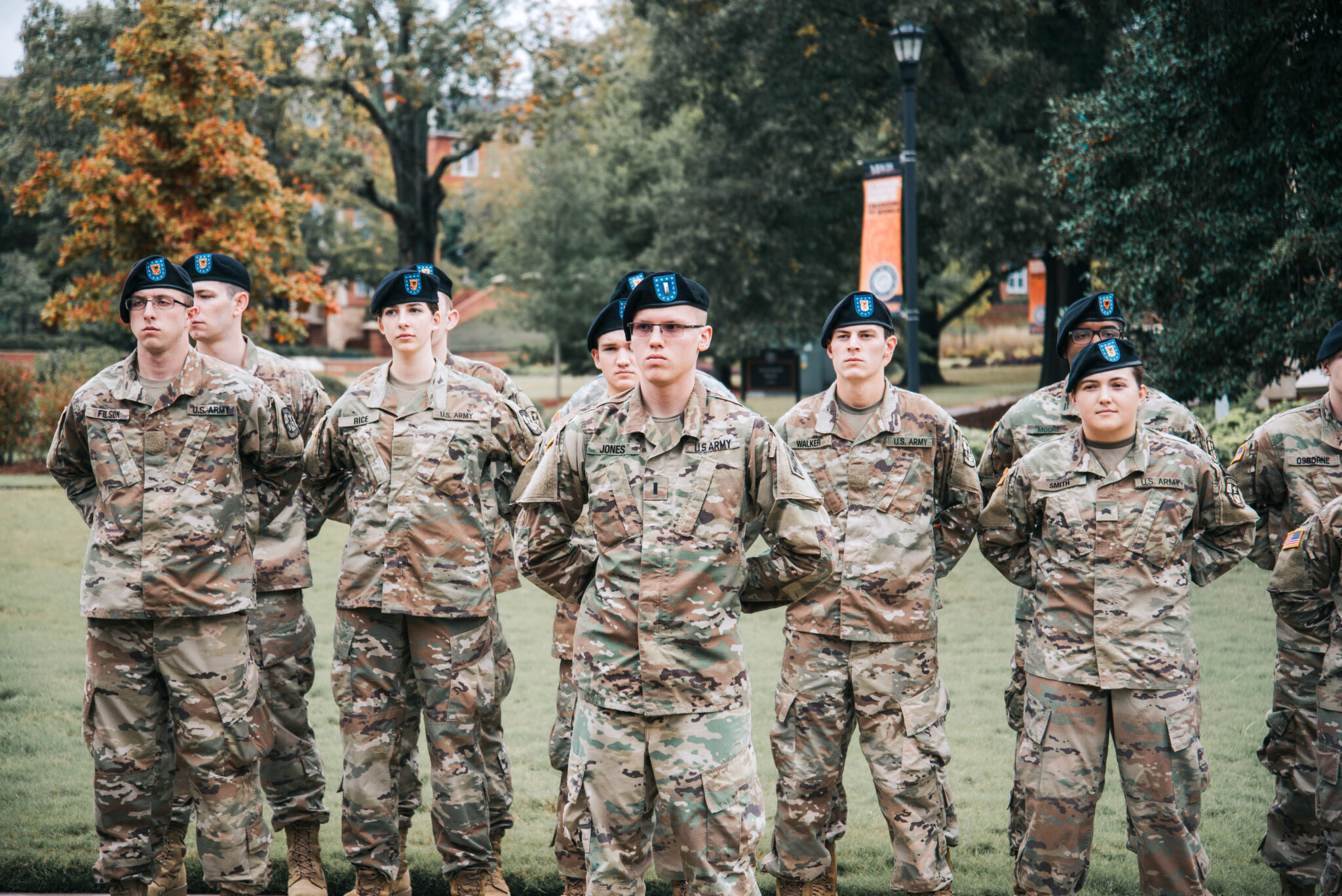 service members standing at attention on campus